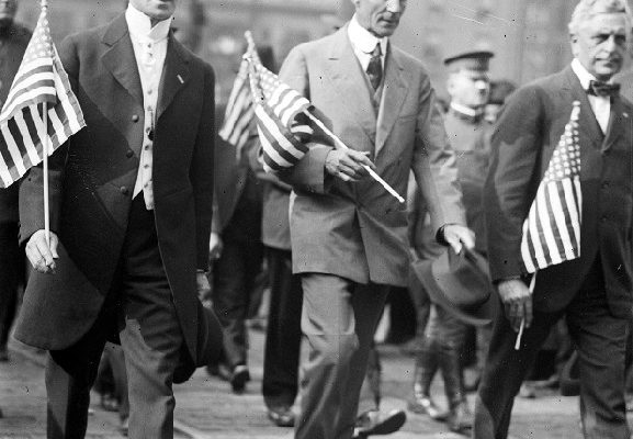 Henry Ford marches with Oscar Marx through the streets of downtown Detroit during the draft parade, circa 1914