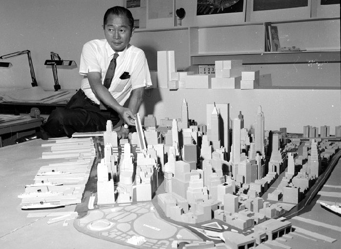 Architect Minoru Yamasaki stands behind an architectural model of New York City, 1958.