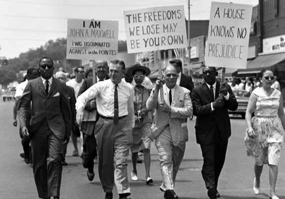 Governor George Romney leads the demonstration against housing discrimination through the “Village” in Grosse Pointe. Second from right is NAACP Detroit president Edward Turner.